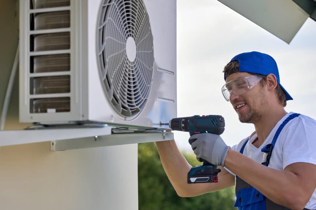 worker installs air conditioner